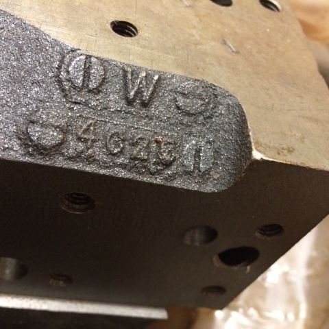 1973 Ford F-100 - A close-up, angled view shows cast-in text on a dark, textured metal part. The text reads "DW" above "3462511".