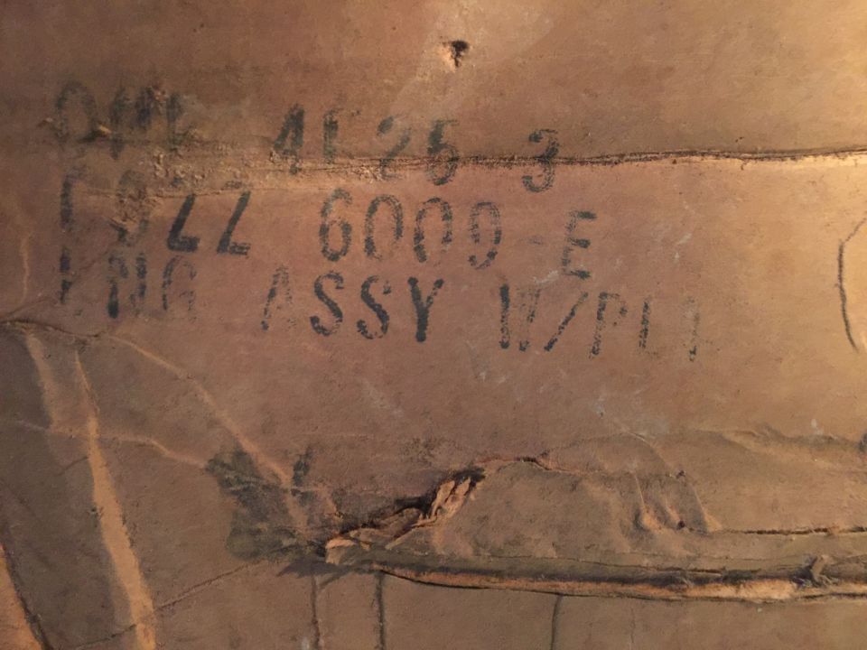 Stenciled text on a brown surface.