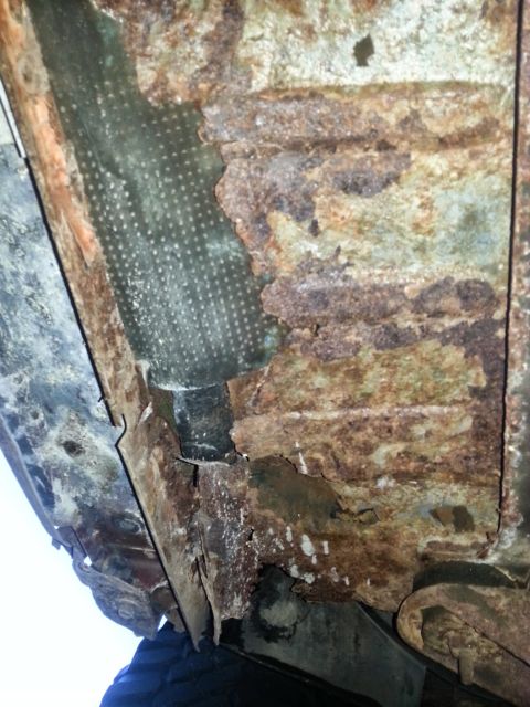 1984 Ford Bronco - Photo of severe rust and rot on a vehicle floor pan and rocker structure.