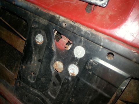 1984 Ford Bronco - Photo of an inner body panel showing mounting bolts and a partially removed component.
