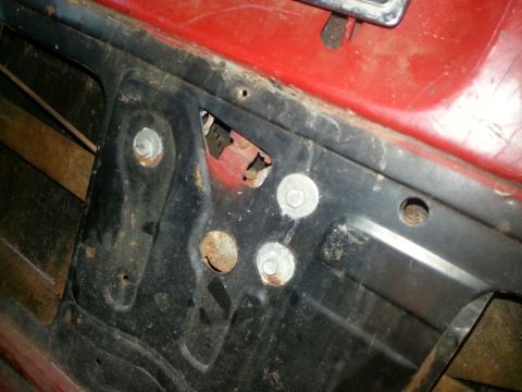 1984 Ford Bronco - Photo of an inner vehicle body panel showing exposed mounting bolts and surface rust.