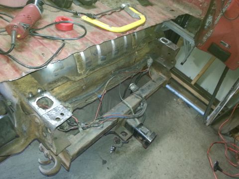 1984 Ford Bronco - Photo of a stripped vehicle frame and body section with exposed wiring during restoration.
