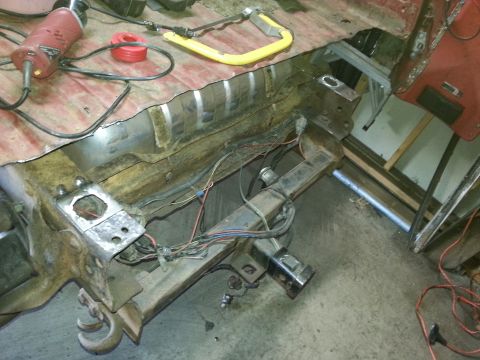 1984 Ford Bronco - Photo of a stripped vehicle frame and body section with exposed wiring during restoration.
