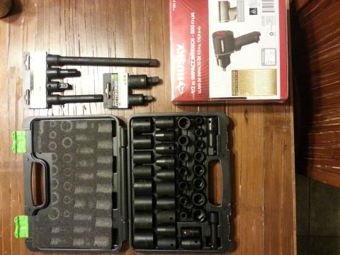 1984 Ford Bronco - Photograph of an open impact socket set and Husky impact wrench retail box on a table, not a technical document.