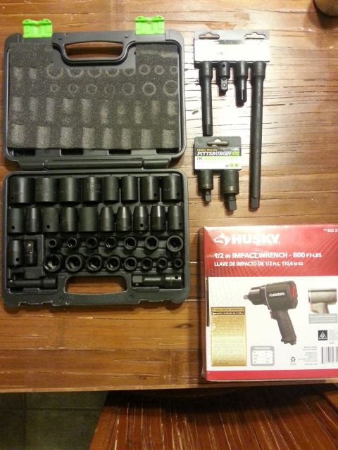 1984 Ford Bronco - Photograph of an impact socket set with adapters and a Husky impact wrench retail box on a table, not a technical document.