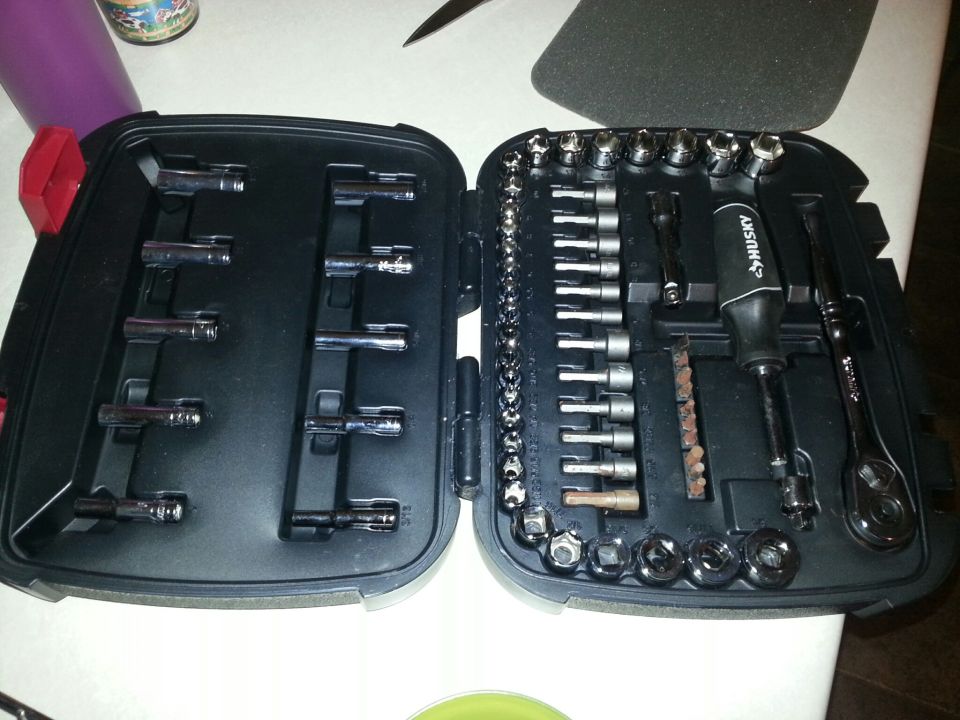 Photo of an open socket and ratchet tool set in a black plastic case