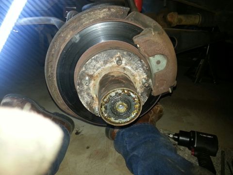 1984 Ford Bronco - Photograph of a brake rotor and exposed wheel hub bearing during front-end service, not a document.
