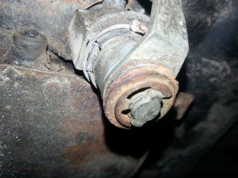 1984 Ford Bronco - Photo of a rusty undercarriage joint on a vehicle, not a document.