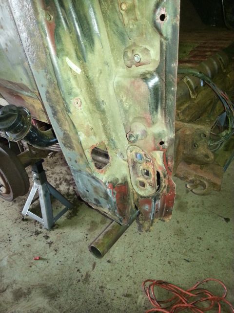 1984 Ford Bronco - Photograph of a corroded vertical body panel during a vehicle restoration, not a document.