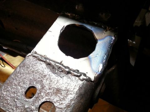 1984 Ford Bronco - Close-up view of a welded metal bracket, likely a component of a vehicle's chassis.