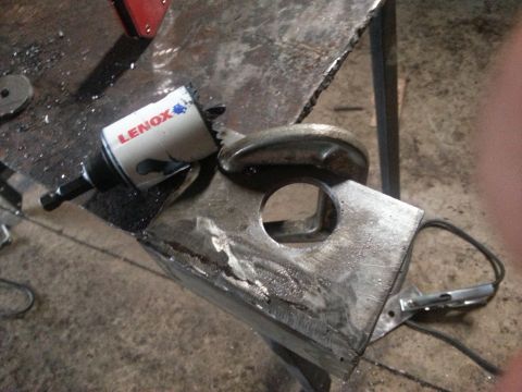 1984 Ford Bronco - A Lenox hole saw is positioned over a metal bracket, with the Supermotors.net logo visible in the lower right corner.