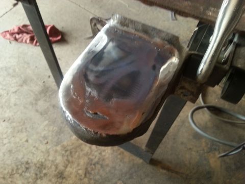 1984 Ford Bronco - A metal component is being worked on, showing signs of repair and modification.