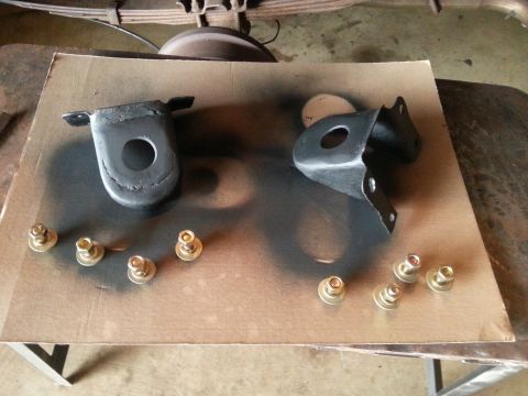 1984 Ford Bronco - These suspension parts and hardware have been painted and are laid out on cardboard for a project.