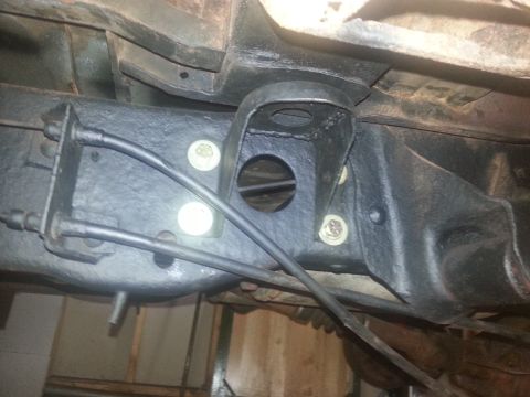 1984 Ford Bronco - Close-up view of the undercarriage frame, showing brake lines and mounting hardware.