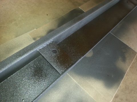 1984 Ford Bronco - A textured metal part is shown in detail, likely a component for a vehicle or other equipment.