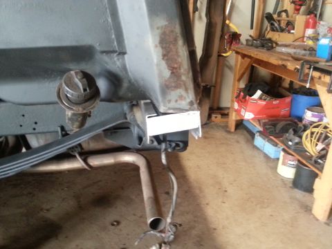 1984 Ford Bronco - Vehicle's rear suspension and exhaust components are visible in a workshop setting.