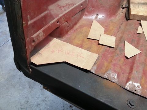 1984 Ford Bronco - Photograph of a pickup bed corner with hand-cut cardboard patch templates labeled DRIVER.