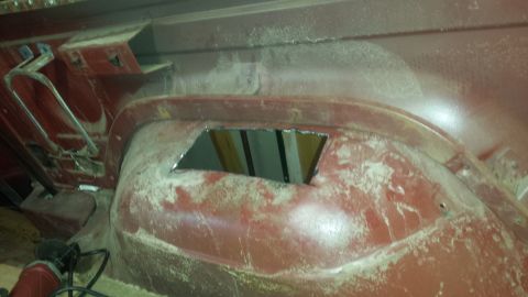 1984 Ford Bronco - Photograph of a pickup rear wheel well with a cut opening and bare sanded body filler.