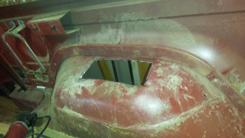 1984 Ford Bronco - Photograph of a pickup rear wheel well with a cut opening and bare sanded body filler.