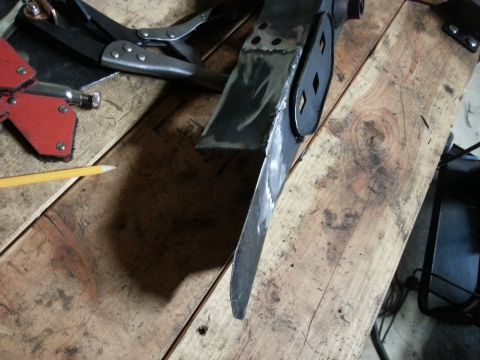 1984 Ford Bronco - Workshop photo of fabricated metal parts, locking pliers, and a pencil on a bench, not a technical document.