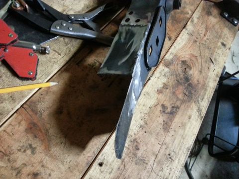 1984 Ford Bronco - Workshop photo of fabricated metal parts, locking pliers, and a pencil on a bench, not a technical document.