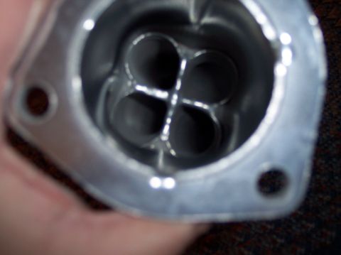 1990 Ford Bronco - Intake manifold runner with four distinct openings, likely from a V8 engine.
