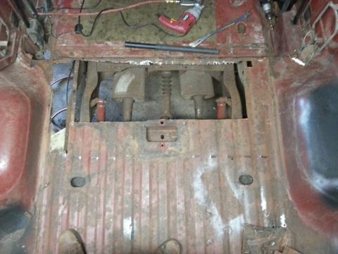 1984 Ford Bronco - Workshop photo of an open floor exposing the transmission during restoration, not a technical document.