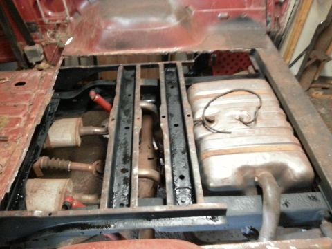 1984 Ford Bronco - Photo of a vehicle's frame and fuel tank exposed from below during restoration.