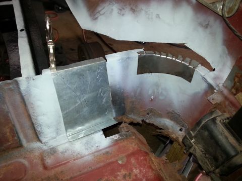 1984 Ford Bronco - Photo of fresh sheet-metal patch panels welded into a corroded floor and wheel-well area.