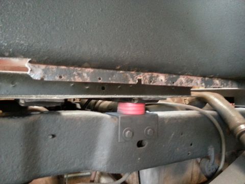1984 Ford Bronco - Photo of a vehicle frame rail and rocker viewed from below during restoration.
