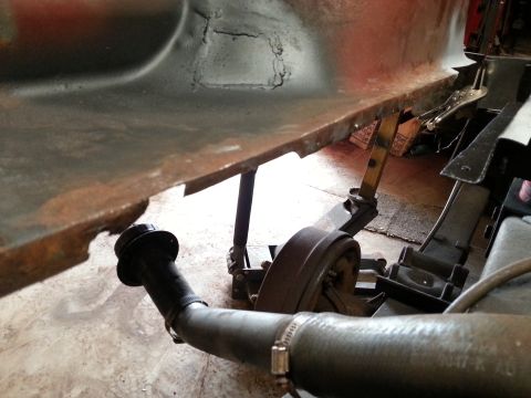 1984 Ford Bronco - Photo of a vehicle's rear suspension and brake drum viewed from underneath during restoration.