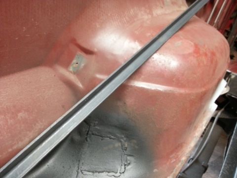 1984 Ford Bronco - Photo of a primered body panel with a welded patch repair during restoration.