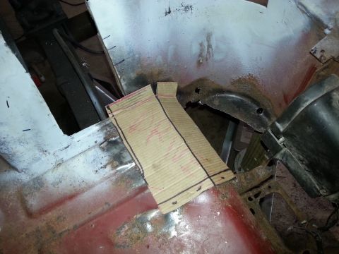 1984 Ford Bronco - Restoration photo of a cardboard fit template over a panel opening, not a technical document.