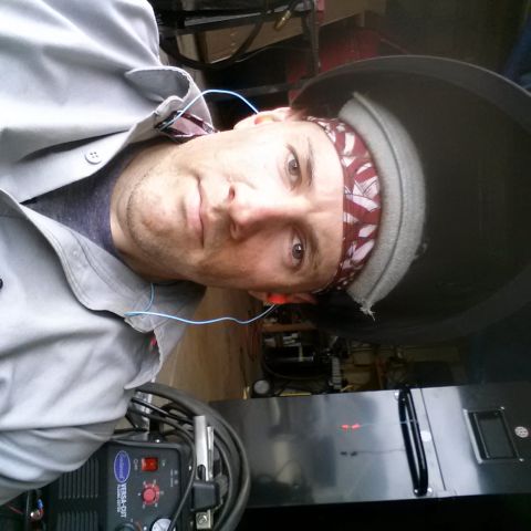 1984 Ford Bronco - Personal selfie of a fabricator beside a plasma cutter, not a technical document.