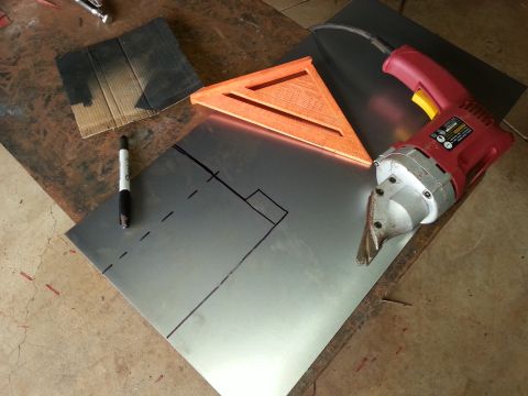 1984 Ford Bronco - Workshop photo of sheet metal being cut with shears and a layout square, not a technical document.