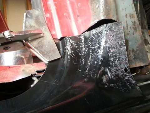 1984 Ford Bronco - Photo of a fresh sheet-metal patch panel clamped in place over a cut-out body section during rust restoration.