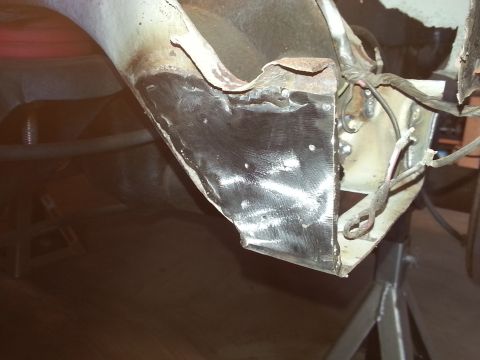 1984 Ford Bronco - Photo of a freshly welded and ground-down corner of bare sheet metal on a body panel under restoration.