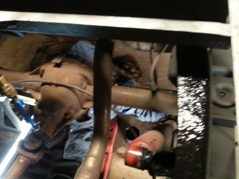 1984 Ford Bronco - Photo of a vehicle underbody showing axle, suspension and exhaust with a welding ground clamp attached.