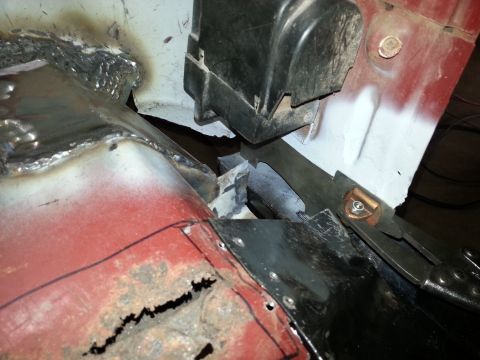 1984 Ford Bronco - Photo of cut and welded inner body panels meeting at a hinge pillar during restoration.