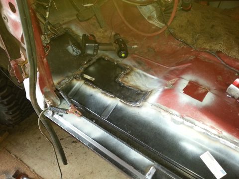 1984 Ford Bronco - Photo of a floor patch panel seam-welded into a vehicle body, with a cordless drill nearby.