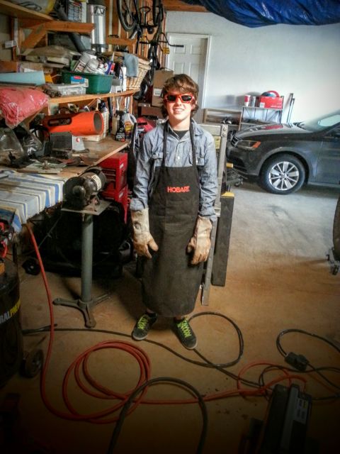 1984 Ford Bronco - Photo of a person in welding gear standing in a home garage, not a technical document.