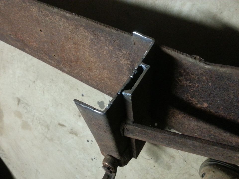 Close view of a welded steel bracket joint between two frame rails