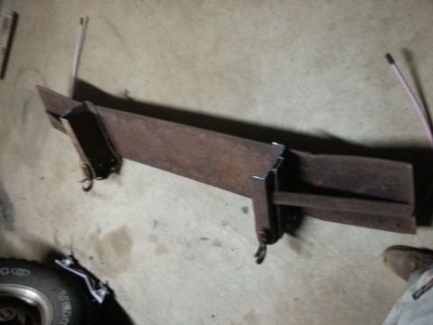 1984 Ford Bronco - Photo of a welded steel cross member with mounts on a garage floor, not a technical document.