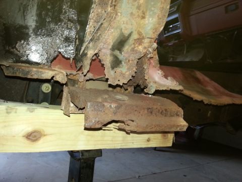 1984 Ford Bronco - Photo of severe frame and body rust on a vehicle undergoing repair, not a technical document.