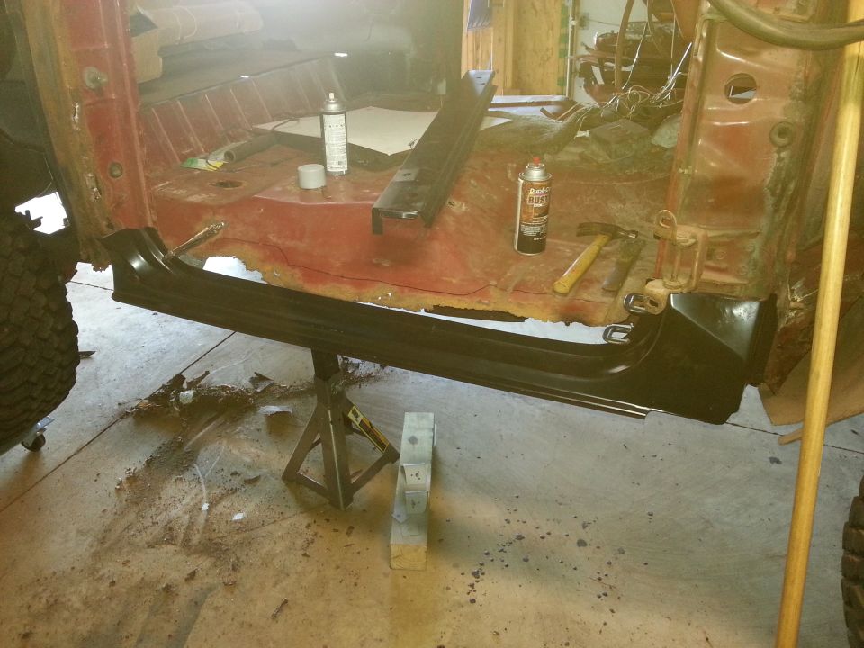 New black rocker panel fitted to a stripped truck body on a jack