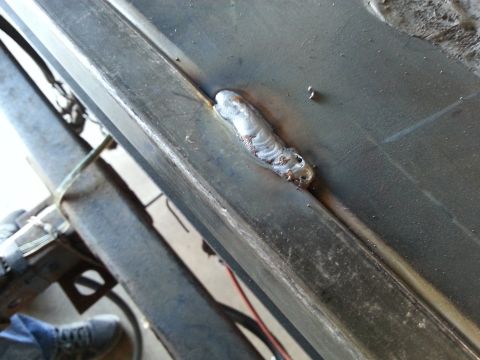 Close-up of a finished weld bead joining two sheet metal panels