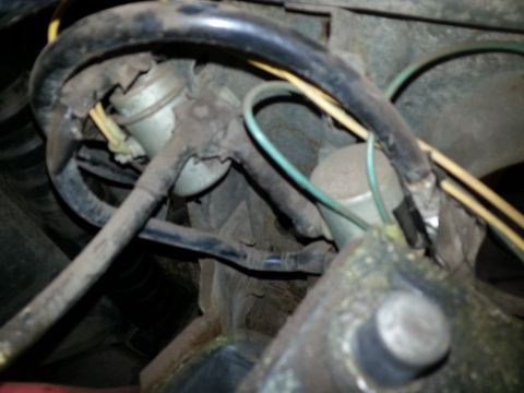 Close-up of vacuum hoses and wiring routed through a classic truck engine bay