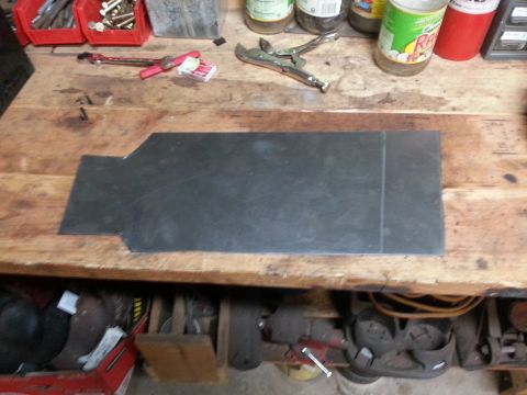 Flat steel patch panel resting on a workbench
