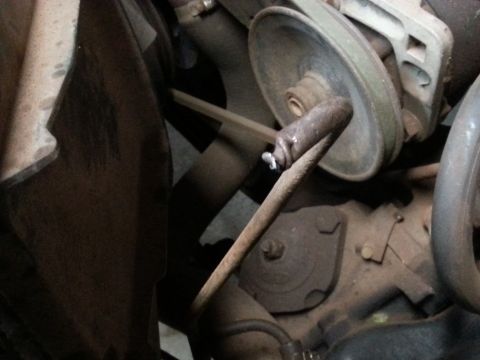 Pulley and belt in a dusty engine compartment