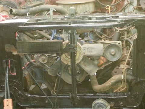 Front engine bay with radiator support and fan during restoration